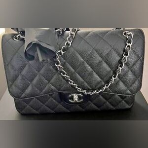 CHANEL Black Quilted Shoulder Bag with Silver Chain Accent